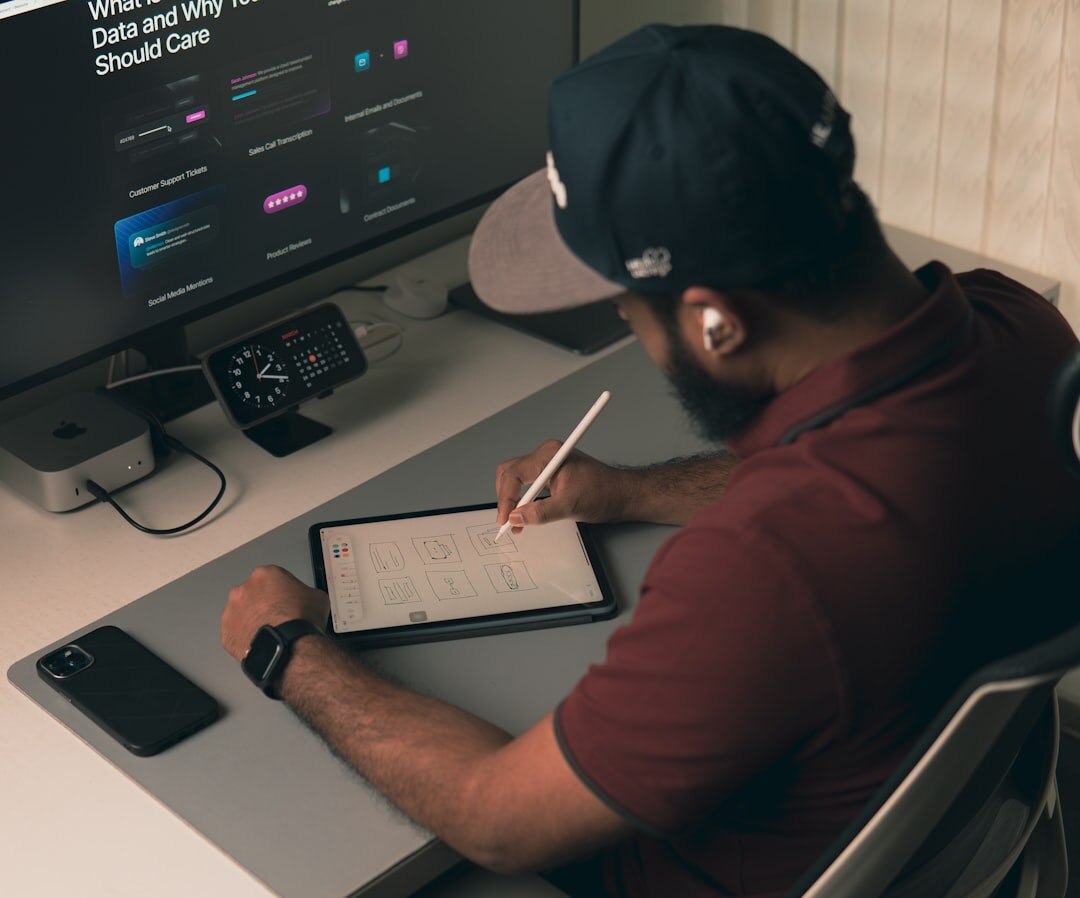 Digital media professional working on multiple screens with social media analytics
